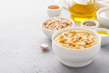 Homemade hummus served with chickpeas, olive oil and paprika.