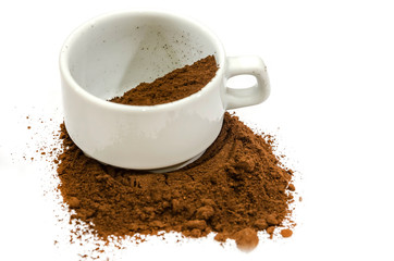 ground coffee in a white cup on a white background