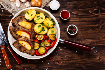 Grilled steak, boiled potatoes and vegetables