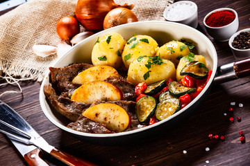 Grilled steak, boiled potatoes and vegetables