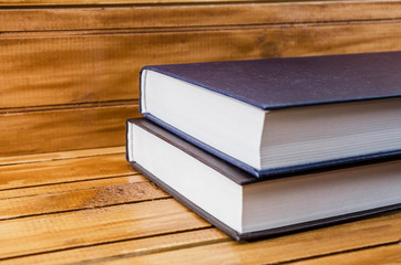 books on a brown, wooden background