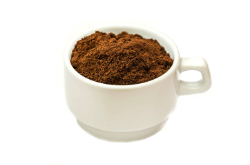 ground coffee in a white cup on a white background