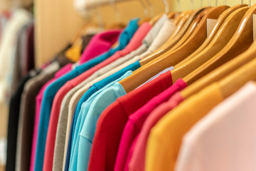 bright colored clothes on a rack