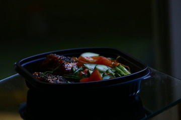 Sesame salmon with teriyaki sauce, noodles and vegetables in bowl