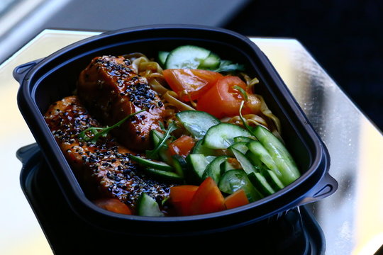 Sesame salmon with teriyaki sauce, noodles and vegetables in bowl