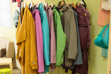 bright colored clothes on a rack