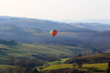 A hot air balloon at sunrise above the Chianti hills south of Florence in Tuscany