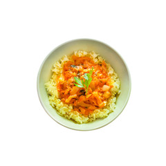 Steamed rice with stewed vegetables and turmeric in a plate isolated
