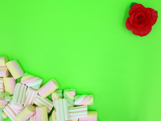Colorful Marshmallows on green background