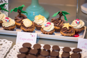 Table with delicious candy, cupcakes, cakepops, macaroons and other sweets