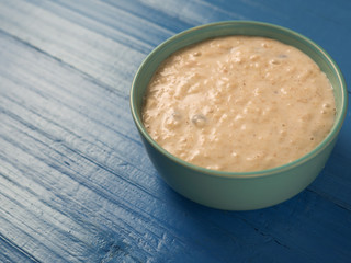 oatmeal in a bowl on a wooden blue table