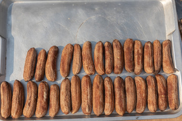 row of dried banana on sunny day at thailand