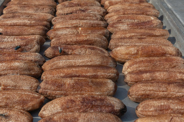 row of dried banana on sunny day at thailand
