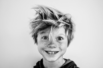 Portrait of a young boy with freckles and wild hair