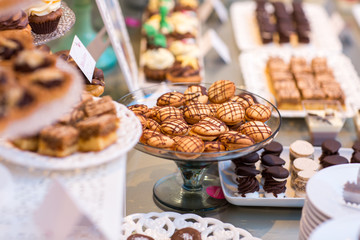 Table with delicious candy, cupcakes, cakepops, macaroons and other sweets