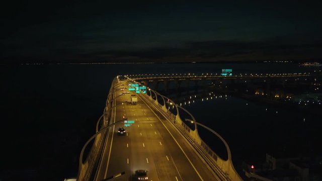 Midnight highway. Autonomous cars on bridge