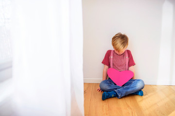 Fototapeta premium Portrait of a young boy wearing pink