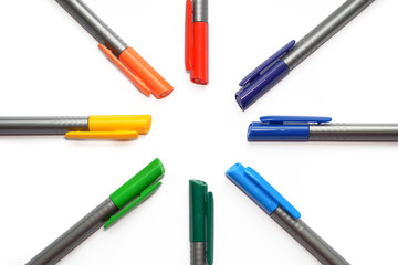 Set of rainbow pens, lying in shape of sun and rays isolated on white background with copyspace