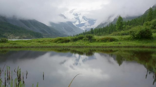 Cinemagraph. Summer nature mountain forest lake landscape, time-lapse.