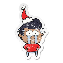distressed sticker cartoon of a crying man wearing santa hat