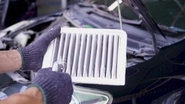 Men are using the blower to clean the air filter car. 