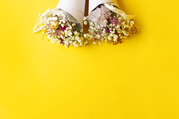 Flowers composition. Frame made of dried flowers on yellow background. conceptual photo of dried flowers 