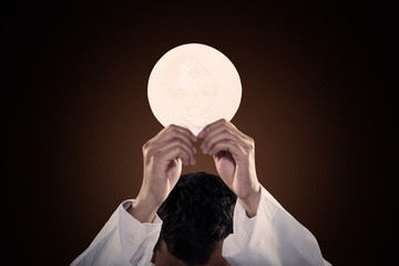 Pastor hands raising a communion bread