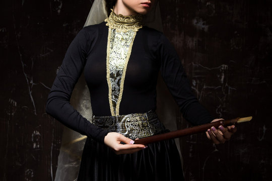 Young woman in armenian national dress with national musical instrument duduk in hands
