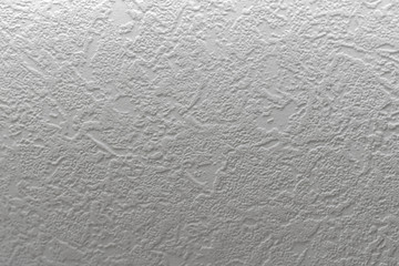 Gray background. Abstract texture of vinyl wallpaper on the wall.