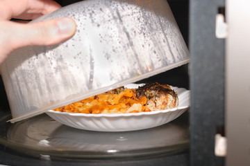 Plate with food warmed in the microwave. The question of the benefits and dangers of radiation...