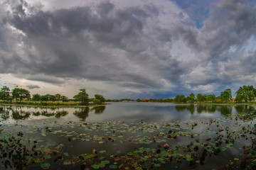 Lake view of dark clouds moving in strong wind with rain storm above the lake, Krajub reservoir in Banpong District, Ratchaburi, Thailand.