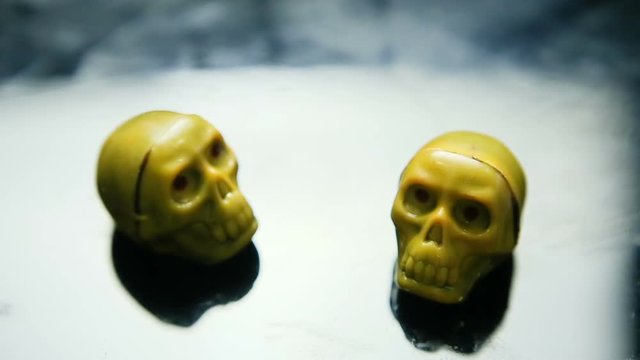 focus in at two yellow chocolate candies in skeleton skull shape on kitchen table