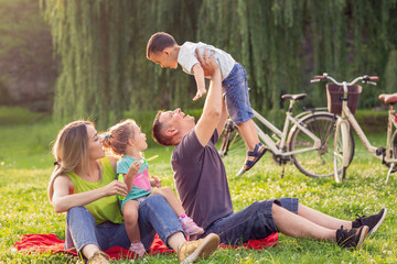 Happy Childhood - father raising his boy up.