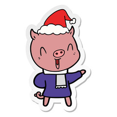happy sticker cartoon of a pig in winter clothes wearing santa hat