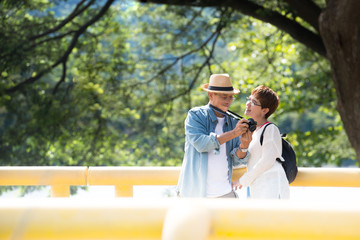 Image of happy romantic Asian senior couple outdoor in park