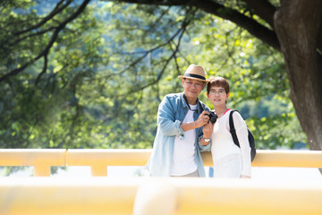 Image of happy romantic Asian senior couple outdoor in park