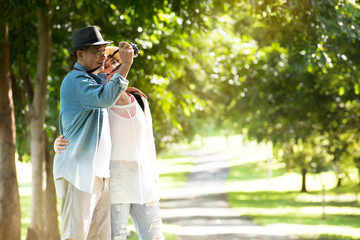 Image of happy romantic Asian senior couple outdoor in park