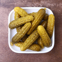 Pickles. Bowl of pickled gherkins cucumber with copy space. Cornichons.