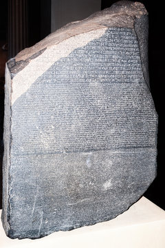LONDON, ENGLAND - OCTOBER 6, 2014 - The Rosetta Stone - inscription in different languages that helped decipher the ancient Egyptian hieroglyphic script