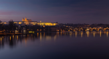 Evening view of Prague Castle and Charles Bridge over Vltava river