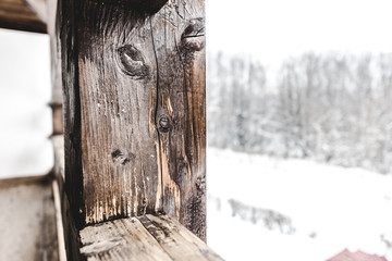selective focus of textured wooden plank on snowy background