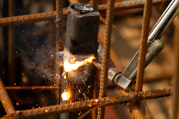 Welder worker perform cutting steel with acetylene torch.