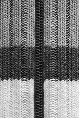 Texture of knitted wool fabric. Woolen cloth with zipper. Striped warm knitting sweater. Background for wallpaper and other elements of your design. Vertical orientation.