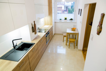 Aesthetic modern narrow kitchen with wooden furnitures