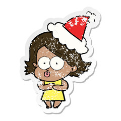 distressed sticker cartoon of a girl pouting wearing santa hat