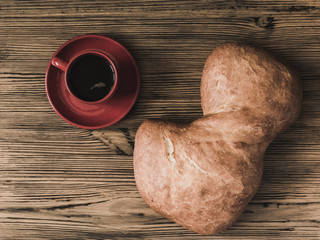 Ciabatta bread and a cup of coffee photographed from above.