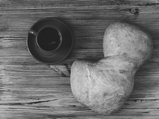 Ciabatta bread and a cup of coffee photographed from above.