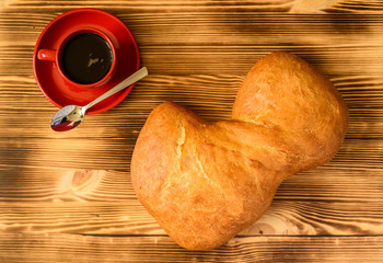 Ciabatta bread and a cup of coffee photographed from above.
