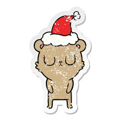 peaceful distressed sticker cartoon of a bear wearing santa hat