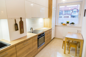 Aesthetic modern narrow kitchen with wooden furnitures